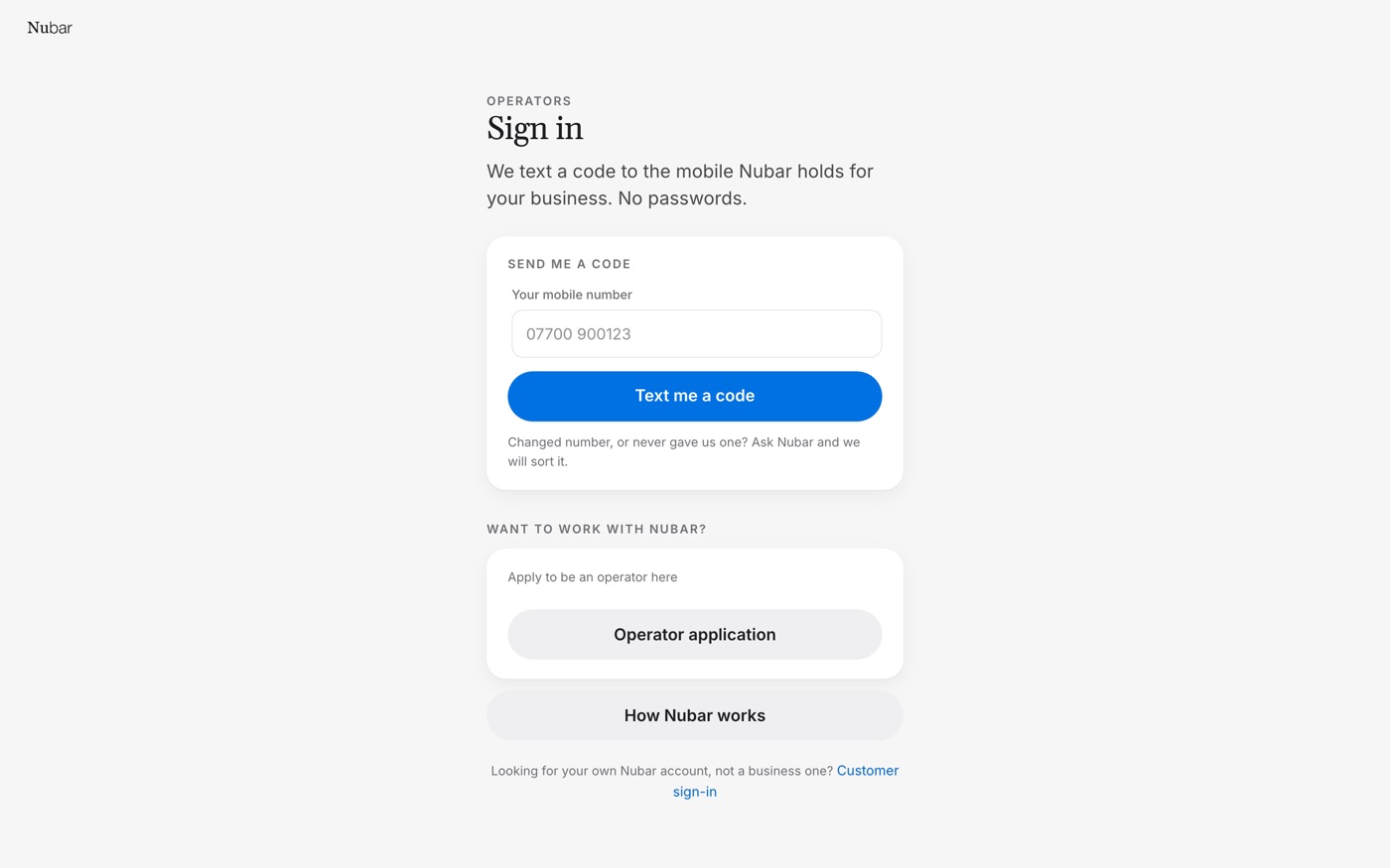 The operator sign-in page on a laptop, asking for a mobile number.